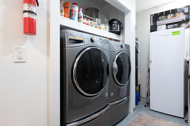 washroom featuring washer and dryer