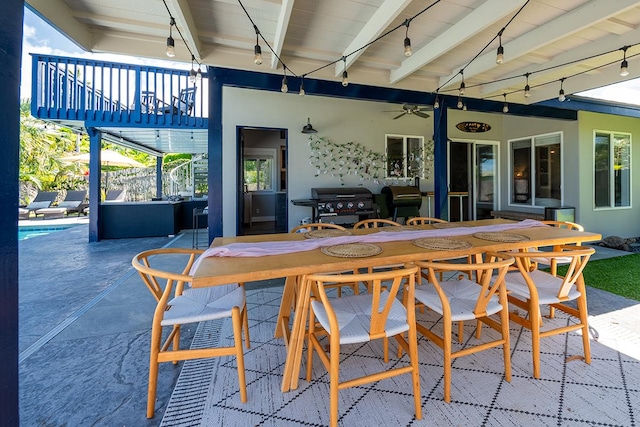 view of patio with a balcony, ceiling fan, and area for grilling