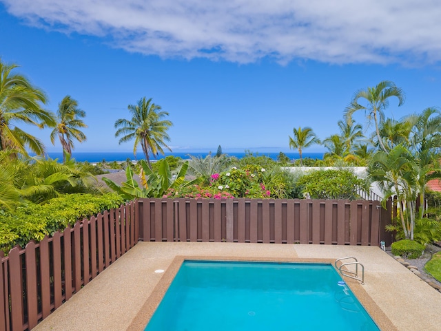 view of swimming pool with a patio area and a water view