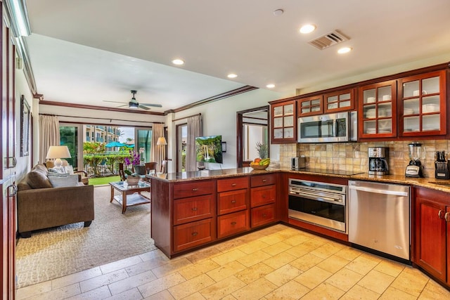 kitchen with backsplash, crown molding, stainless steel appliances, and kitchen peninsula