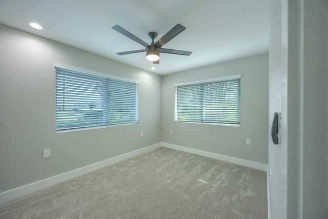 carpeted spare room with ceiling fan and a healthy amount of sunlight