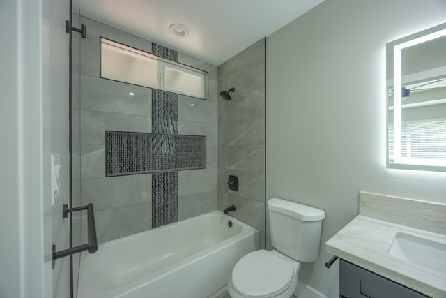 full bathroom with toilet, tiled shower / bath combo, and vanity