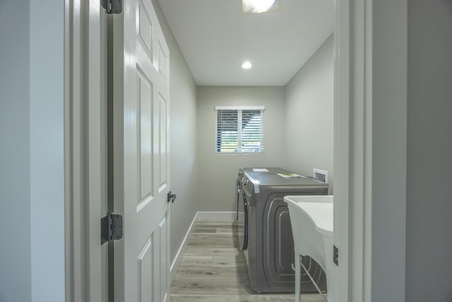 laundry area featuring independent washer and dryer and light wood-type flooring