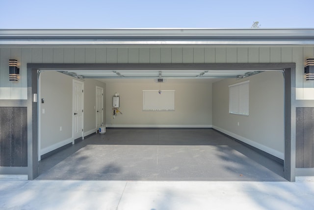 garage featuring a garage door opener and tankless water heater