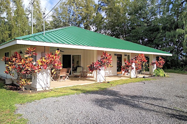 view of front of home featuring ceiling fan and a patio