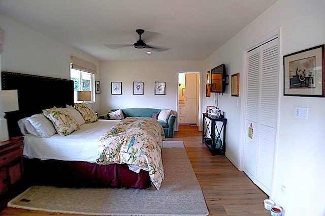 bedroom featuring ceiling fan, a closet, and hardwood / wood-style flooring