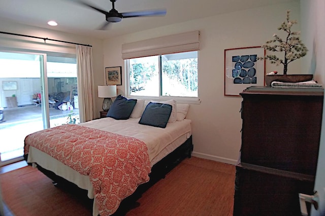 bedroom featuring ceiling fan, access to exterior, and multiple windows