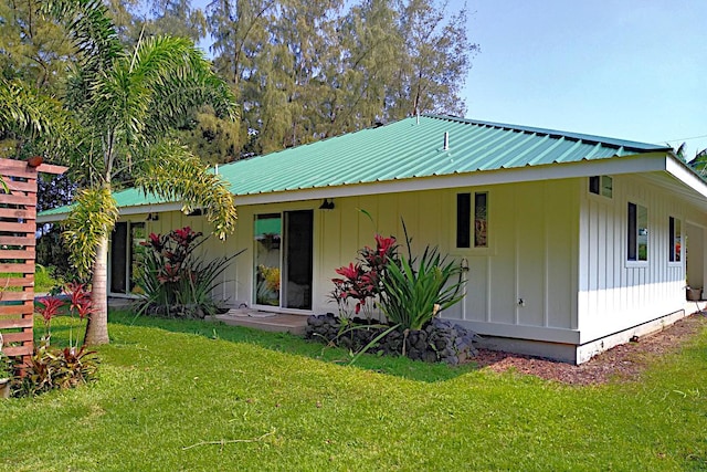 rear view of house with a yard