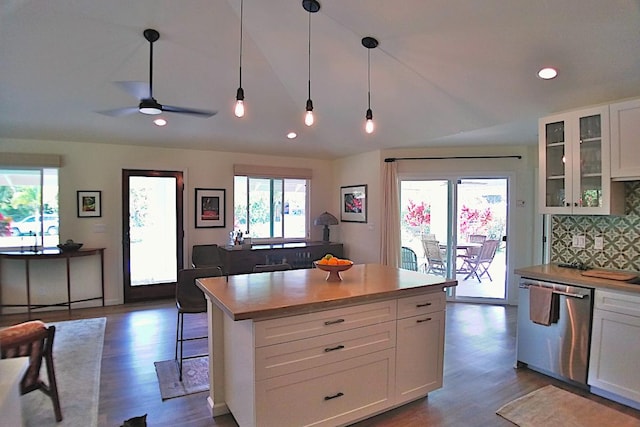 kitchen with white cabinetry, stainless steel dishwasher, a center island, and hanging light fixtures