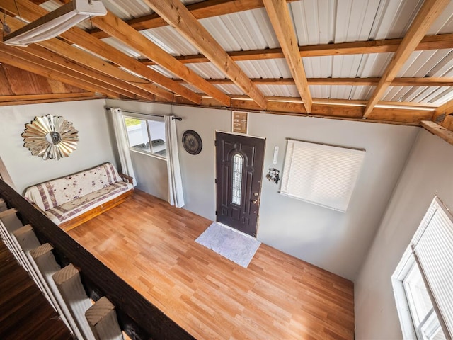 foyer entrance featuring wood-type flooring and beam ceiling