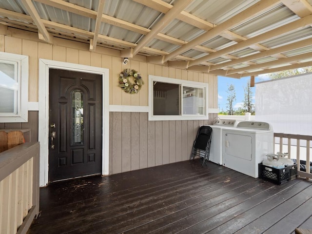 property entrance with a wooden deck and independent washer and dryer