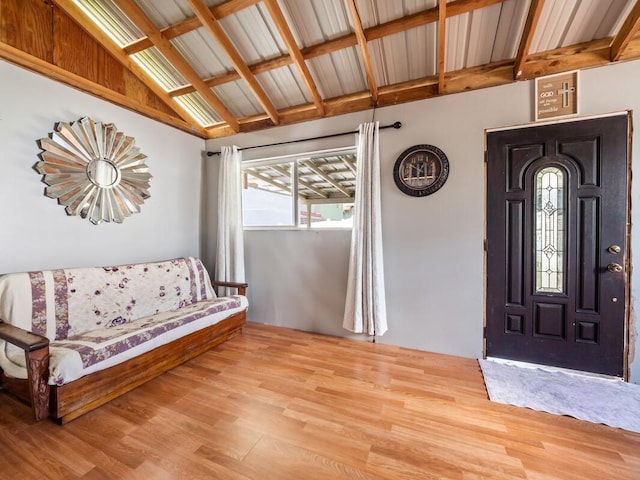 foyer with light hardwood / wood-style flooring and lofted ceiling