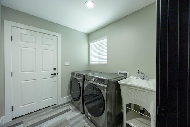 15-1836 11th Ave, Keaau, HI 96749 - laundry room featuring washer and dryer, a sink, laundry area, baseboards, and light wood-style floors