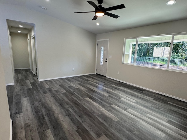 interior space with ceiling fan, dark hardwood / wood-style flooring, and lofted ceiling