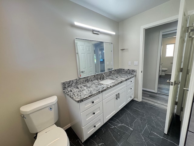 bathroom featuring vanity and toilet