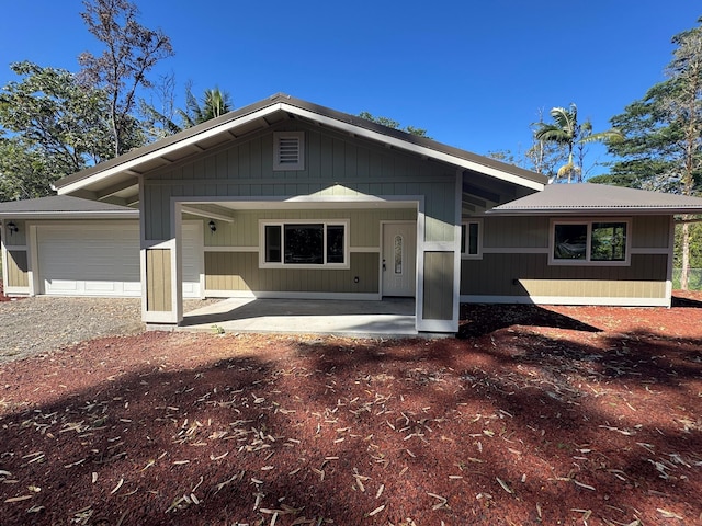 single story home featuring covered porch and a garage