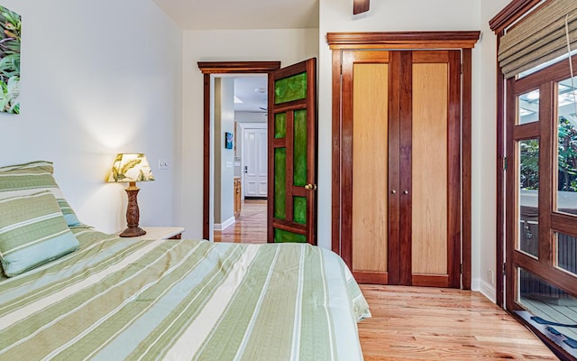 bedroom featuring access to exterior and light hardwood / wood-style flooring