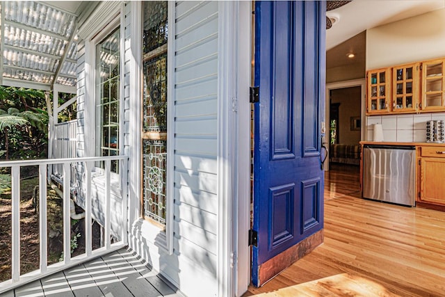 view of exterior entry with a pergola