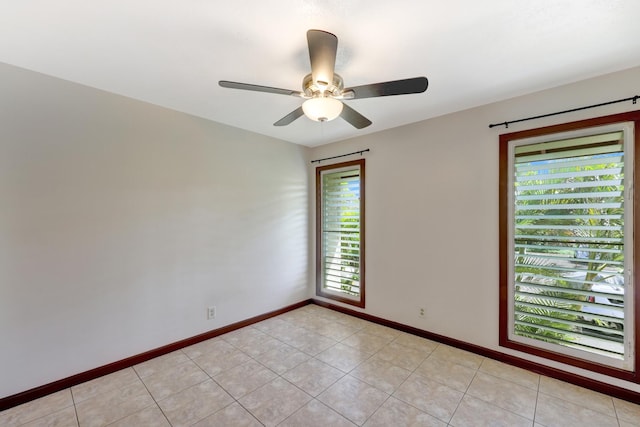 empty room featuring ceiling fan and light tile patterned floors