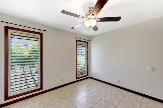 spare room featuring ceiling fan and light tile patterned floors