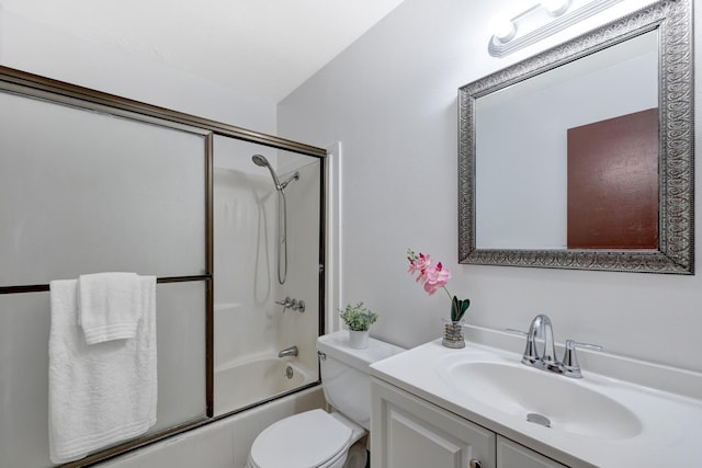 full bathroom featuring toilet, bath / shower combo with glass door, and vanity