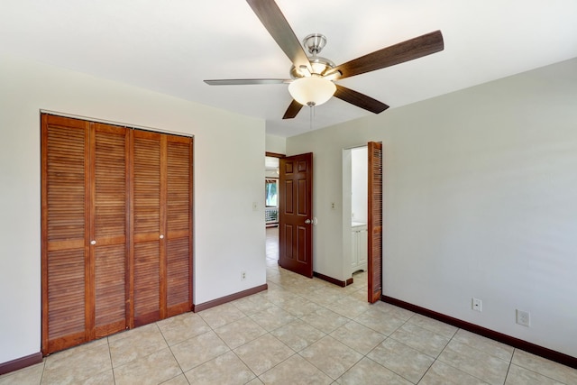 unfurnished bedroom with a closet, light tile patterned floors, and ceiling fan