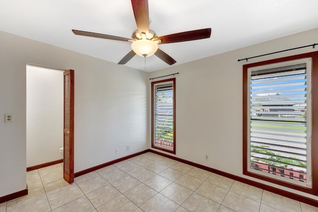 spare room featuring ceiling fan and light tile patterned flooring