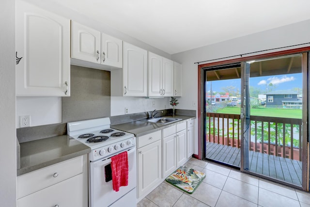 kitchen featuring white cabinets, electric range, sink, and a healthy amount of sunlight