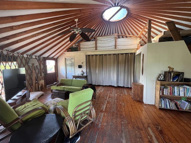 living room featuring hardwood / wood-style flooring, vaulted ceiling, ceiling fan, and wood walls