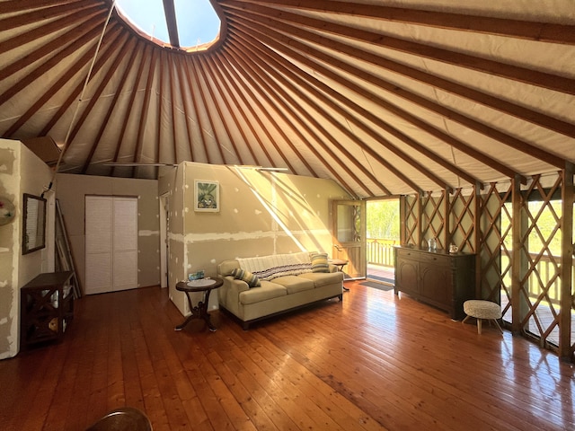 additional living space featuring wood-type flooring and vaulted ceiling