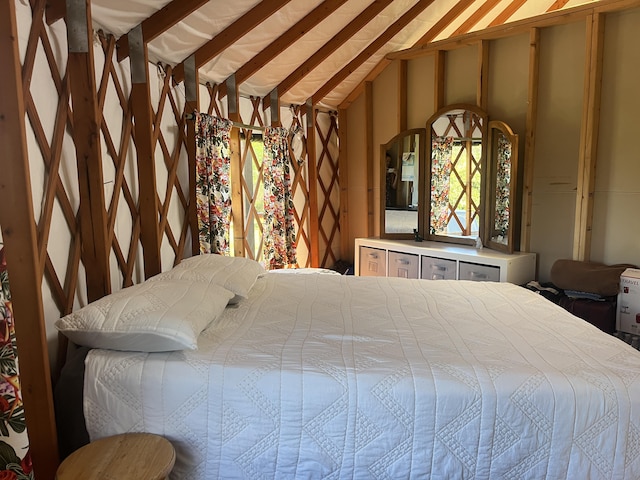 bedroom featuring lofted ceiling with beams