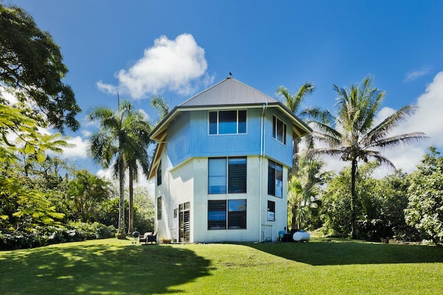 rear view of property with a lawn