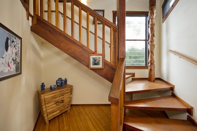 stairs with hardwood / wood-style floors