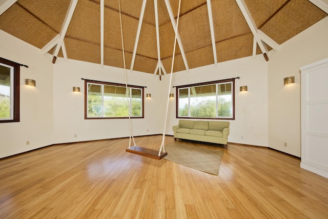 interior space with beamed ceiling, wood ceiling, hardwood / wood-style flooring, and high vaulted ceiling