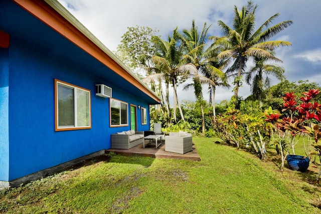 view of yard featuring an AC wall unit, outdoor lounge area, and a patio area