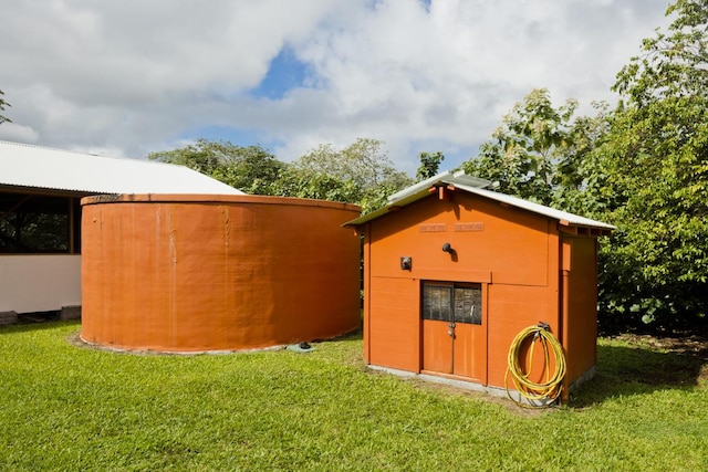 view of outdoor structure with a lawn