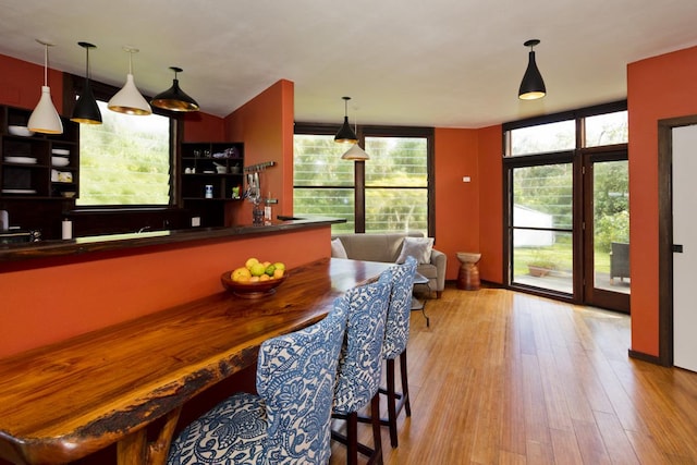 dining room with expansive windows and light wood-type flooring