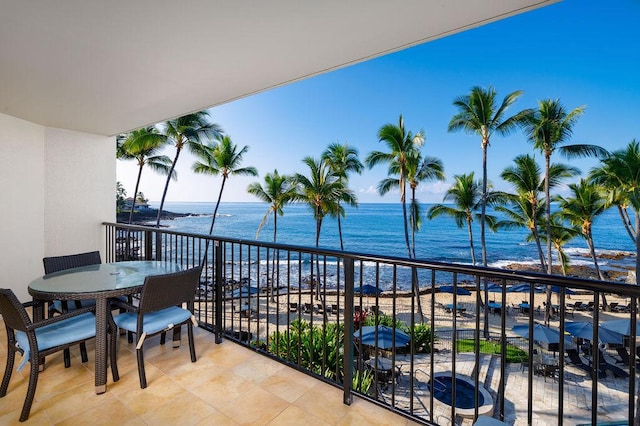 balcony featuring a water view and a view of the beach