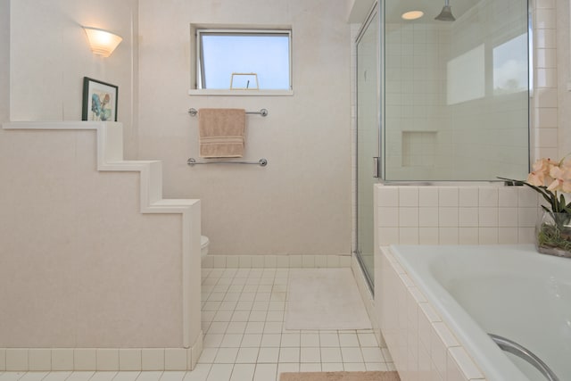 bathroom with toilet, tile patterned floors, and plus walk in shower