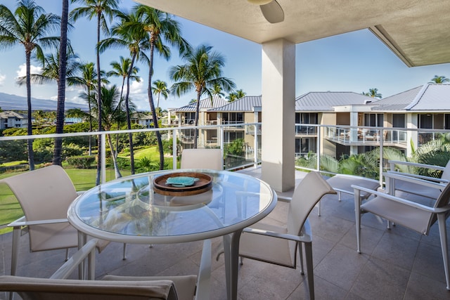 view of patio featuring ceiling fan and a balcony