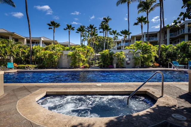 view of pool with a hot tub