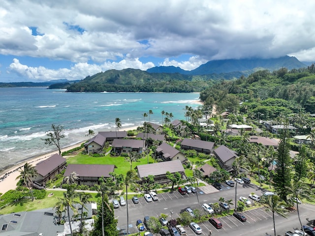 aerial view with a water and mountain view and a beach view