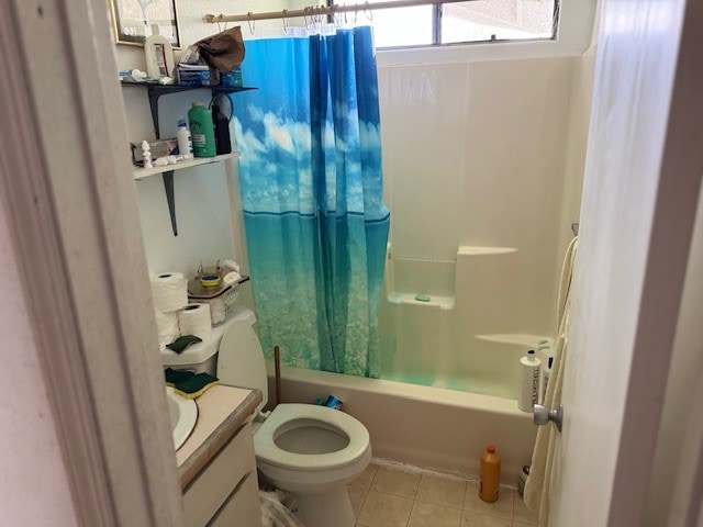 full bathroom featuring toilet, vanity, tile patterned flooring, and shower / bath combo