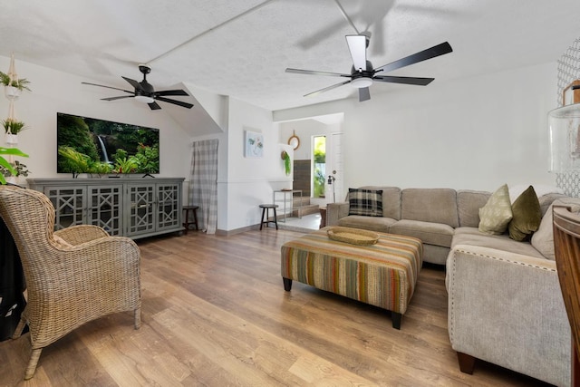 living room with a textured ceiling and wood-type flooring