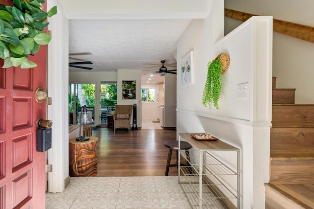 entryway with hardwood / wood-style floors and beam ceiling