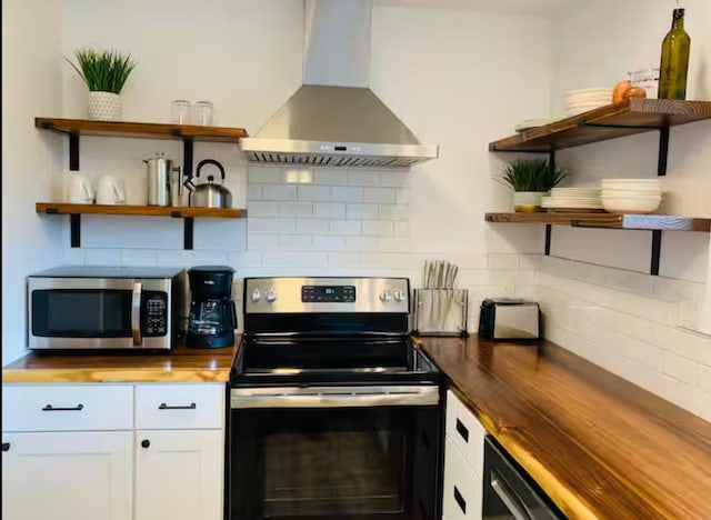 kitchen featuring wood counters, ventilation hood, stainless steel appliances, backsplash, and white cabinets