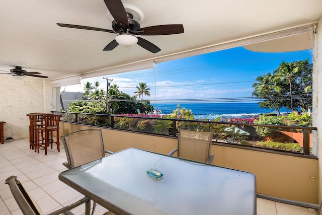 view of patio / terrace with ceiling fan and a water view