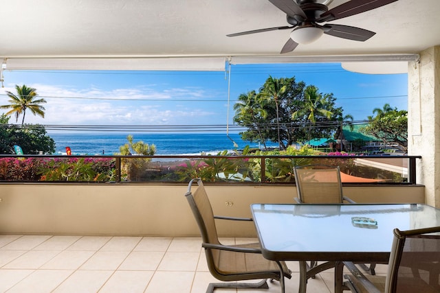 balcony featuring ceiling fan and a water view