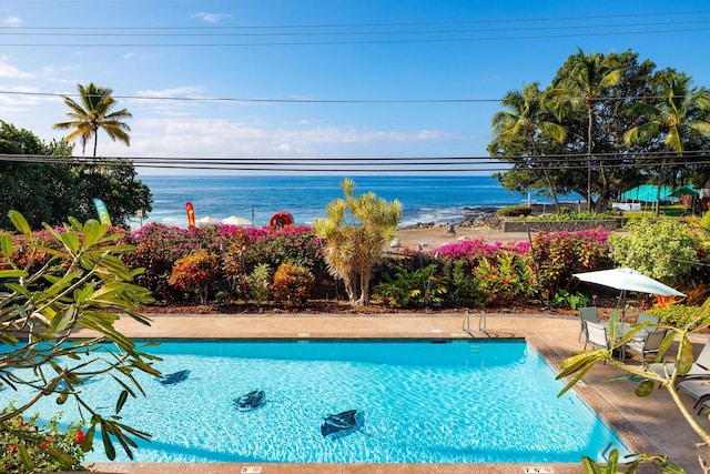 view of swimming pool with a water view