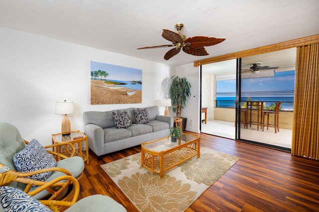 living room featuring dark hardwood / wood-style flooring, floor to ceiling windows, and ceiling fan